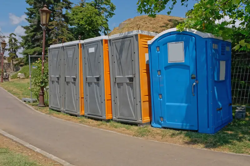 Temporary toilets cabins wc in city park summer festival